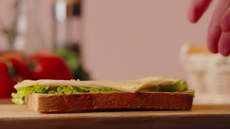 making a cheese and ham sandwich