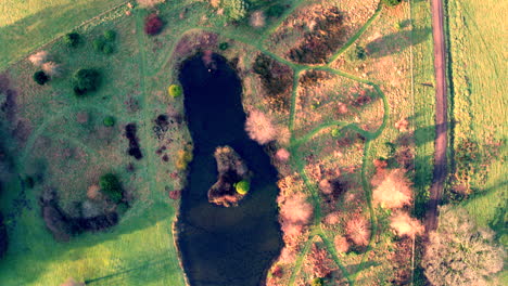 pond view from above with park walkways in autumn colour in scotland