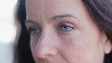 close up shot of attractive mature lady with blue eyes looking aside