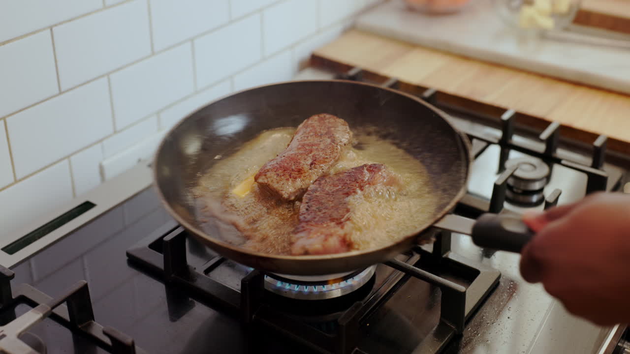 Steak cooking in a pan