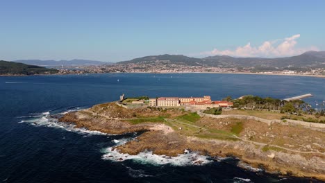 aerial - monterreal castle on a rocky peninsula in baiona, spain, overlooking the atlantic