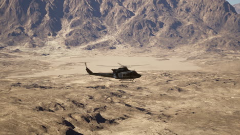 helicopter flying over desert mountains