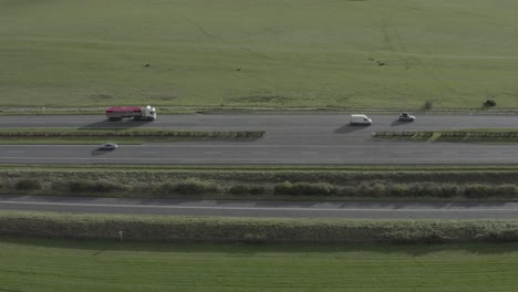 Six-traffic-lanes-on-highway-aerial-with-green-pasture-on-both-sides