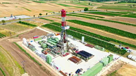 aerial view of oil drilling rig and equipments on the rural fields - natural oil and gas