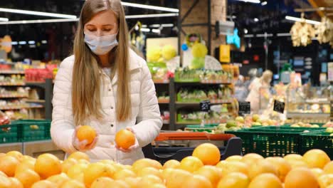 young woman puts on a protective mask against the virus. weekdays during a pandemic, protection. woman in black protective mask looking at the camera