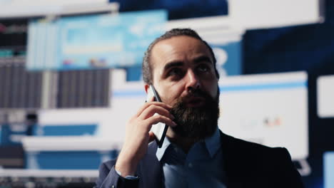 professional businessman answering a phone call surrounded by kpi metrics