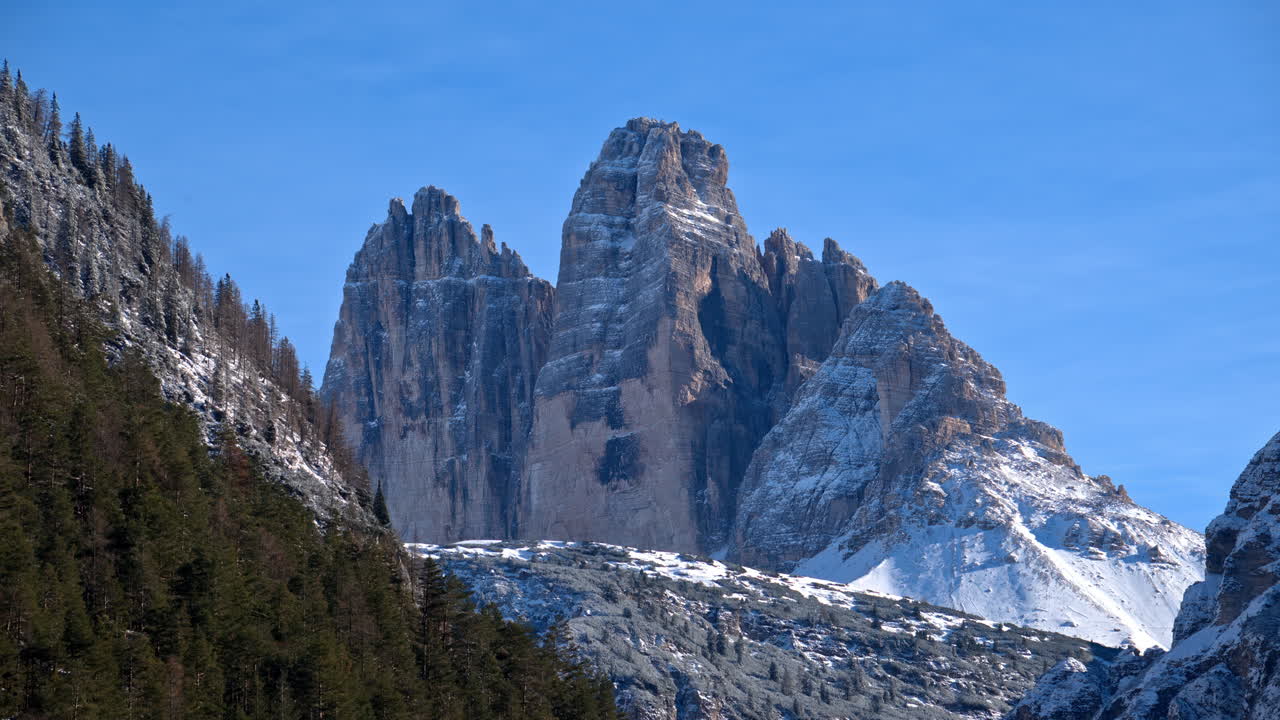 View of snow on the trees and mountains in the Dolomites, Italy with the cloudy sky on the background