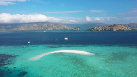 Ausgezeichnete-Luftaufnahme-Von-Touristen-Auf-Und-Kleinen-Motorbooten-In-Der-Nähe-Von-Sand-Island-Im-Indonesischen-Komodo-Nationalpark