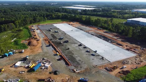 A-wide-shot-reveals-a-massive-concrete-pad-that-is-half-poured