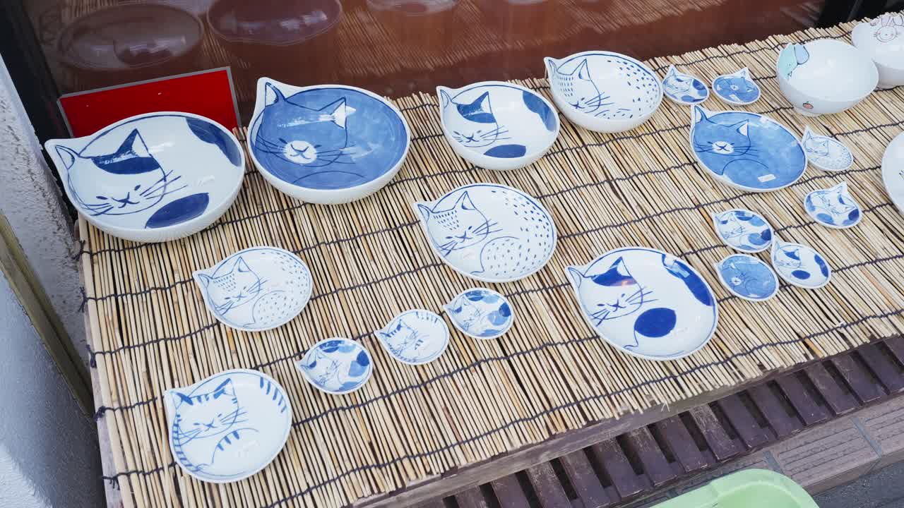 A collection of charming, hand-painted ceramic dishes with various cat designs on display