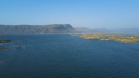 wide aerial view of karamchat dam in bihar, with the river’s tranquil flow complementing the majestic structure.