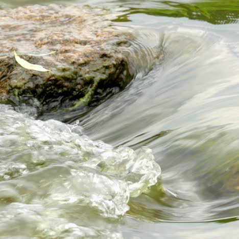 fast flowing river with stones in the water 4k