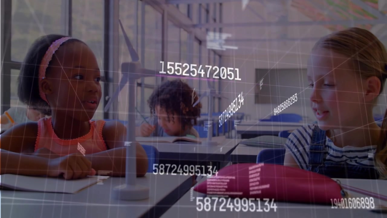 Girl in pink top spinning wind turbine blade in classroom viewing holographic data for learning