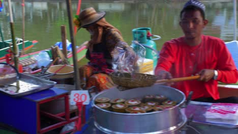 thai man making a sale of a typical snack through a basket to get the money