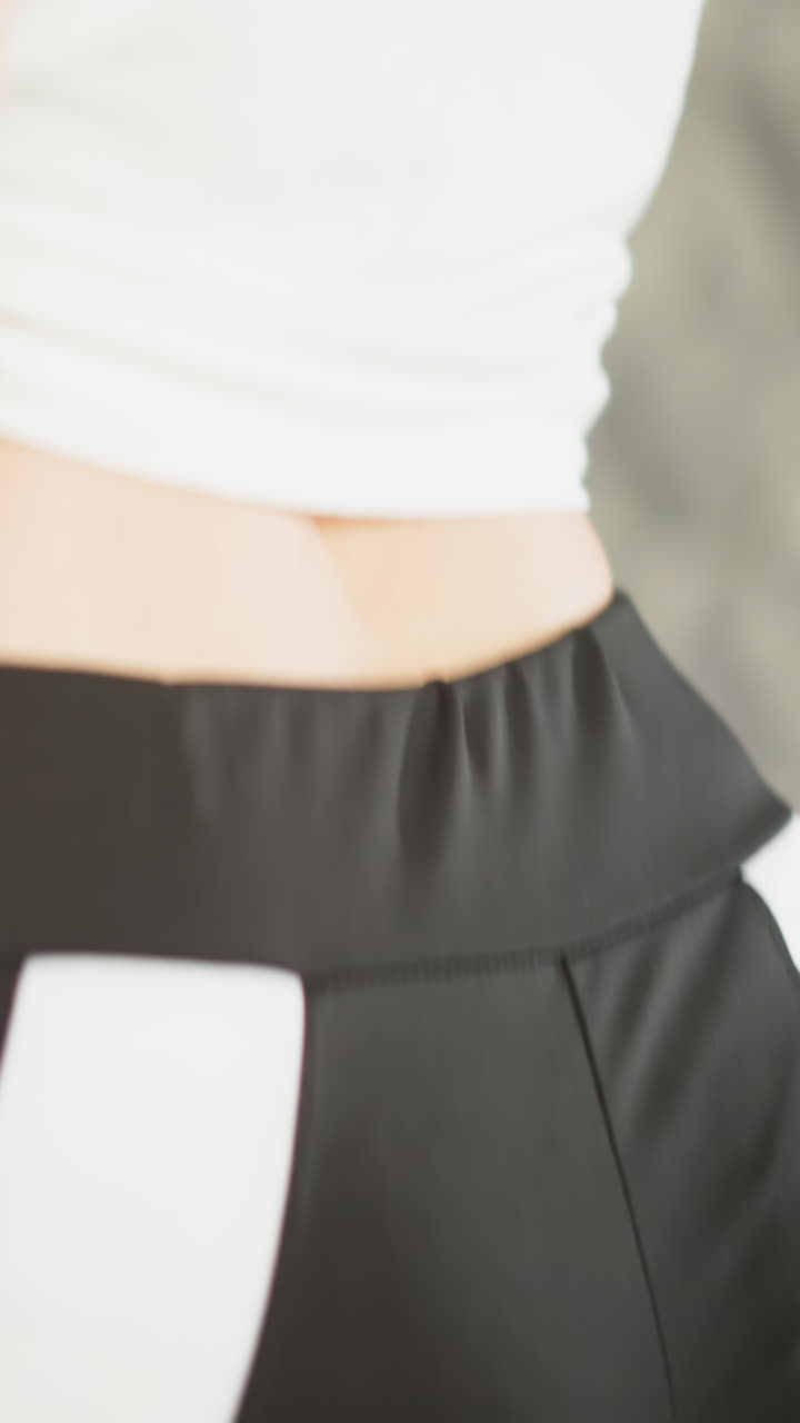 Woman runs on training machine at home closeup. Strong lady in leggings jogs fast on treadmill in house gym. Athlete conducts domestic workout