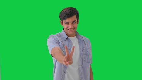 Happy-Indian-boy-showing-victory-sign-Green-screen