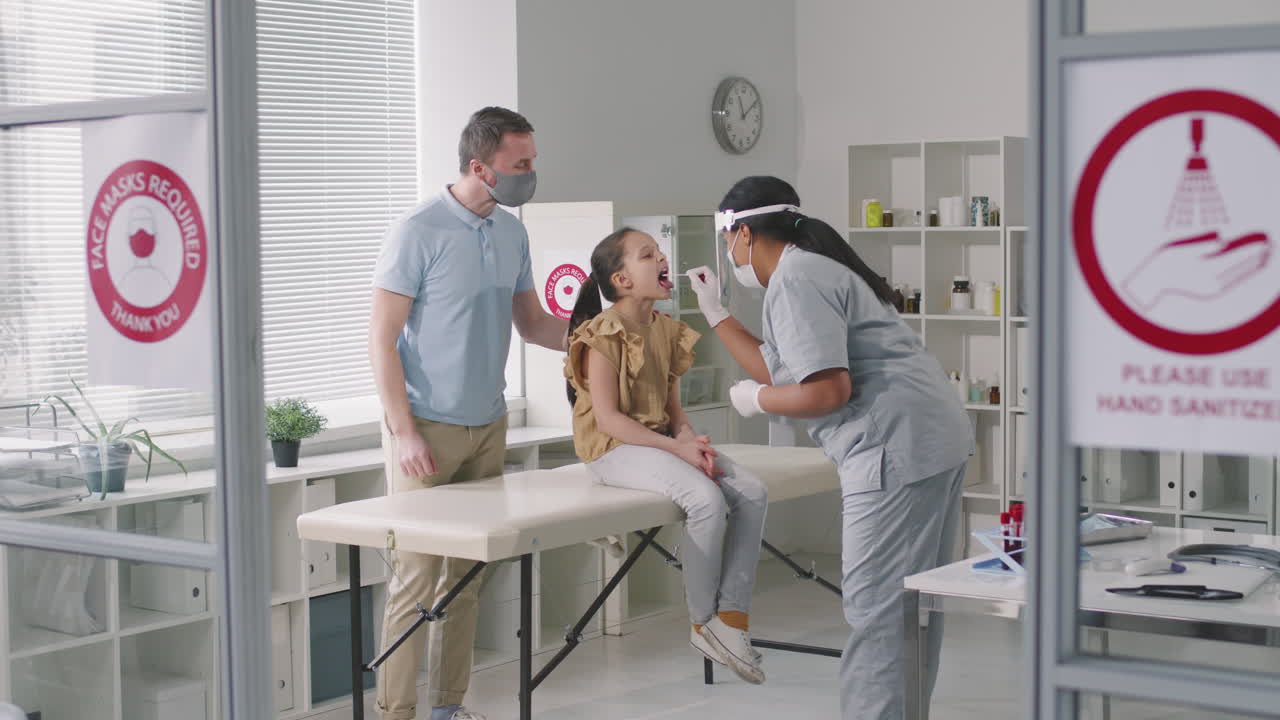 Child Being Covid Tested In Clinic