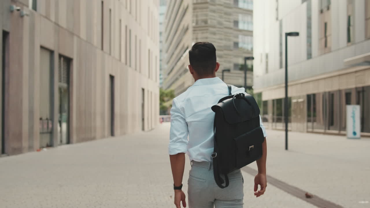 Man with backpack walking in the city