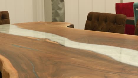 Beautiful-finish-of-a-wooden-and-marble-proxy-table-furniture-on-display-in-Stuttgart,-Baden-wurttemberg,-Germany-Europe,-panning-view-angle