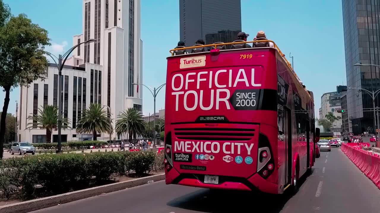 Traffic flows on Paseo de la Reforma, view of Caballito monument in Mexico City