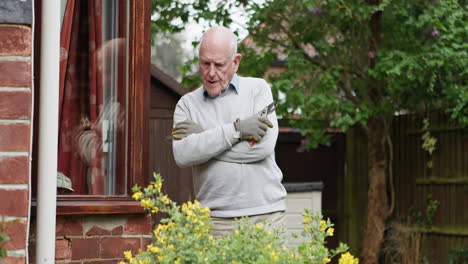 elderly man gardening in his yard