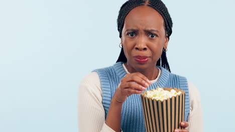Scared,-popcorn-and-face-of-a-black-woman