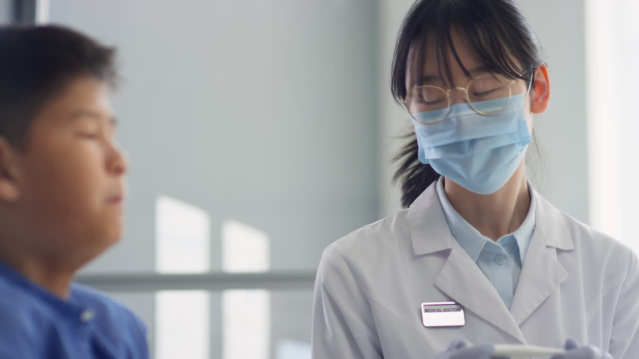 Sick Asian Boy Visiting Female Doctor