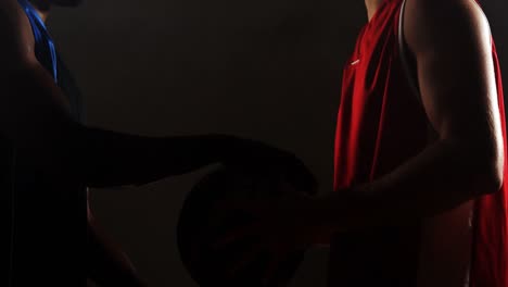 basketball players challenging each other