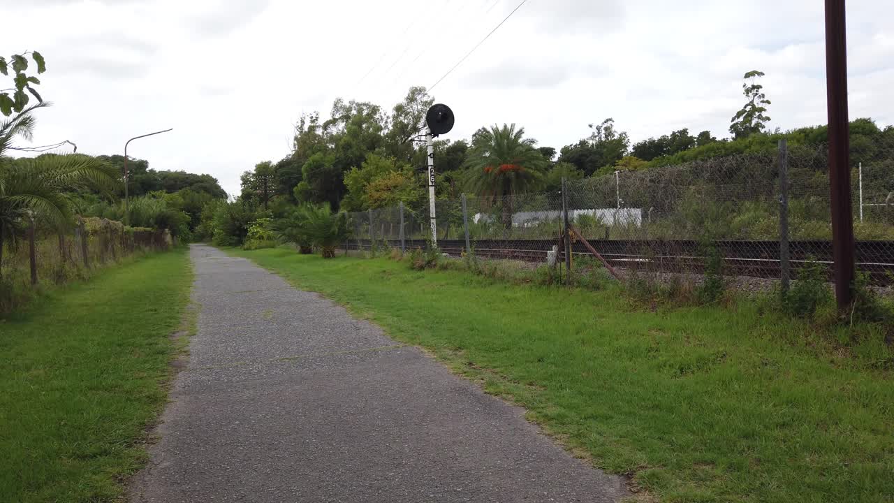 Panning view at empty railway sideways, rural landscape at daylight, location in quiet countryside area