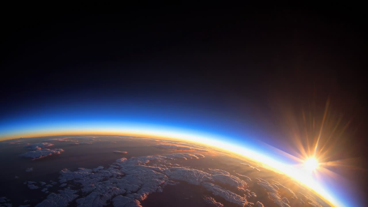 A stunning video frame of Earth's horizon from space, captured at a low angle, showcasing a vibrant