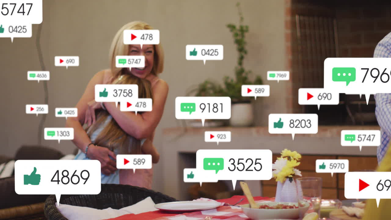 Mid-adult woman hugging daughter at home dining table, with floating social media marketing icons