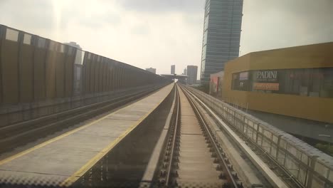 kuala lumpur, malaysia -july 8, 2019: passengers record the mass rapid transit movement from the back of the train