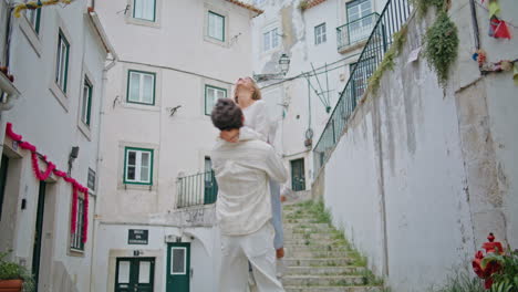 strong macho swirling girlfriend at tiny street zoom on. newlyweds having fun