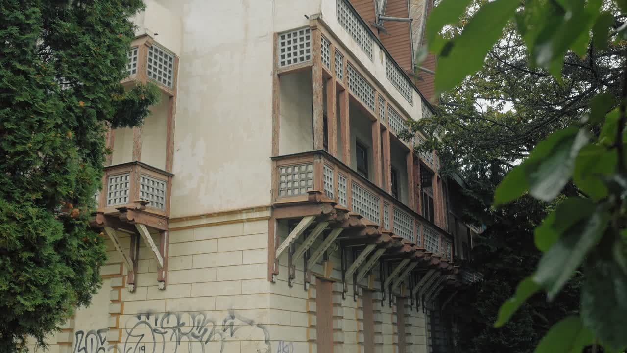 녹색 잎 을 통해 볼 수 있는 버려진 건물 의 업