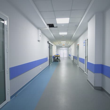 empty hallway in the hospital. long hospital bright corridor with rooms