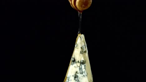 Macro-video-of-honey-being-poured-onto-Gorgonzola-cheese