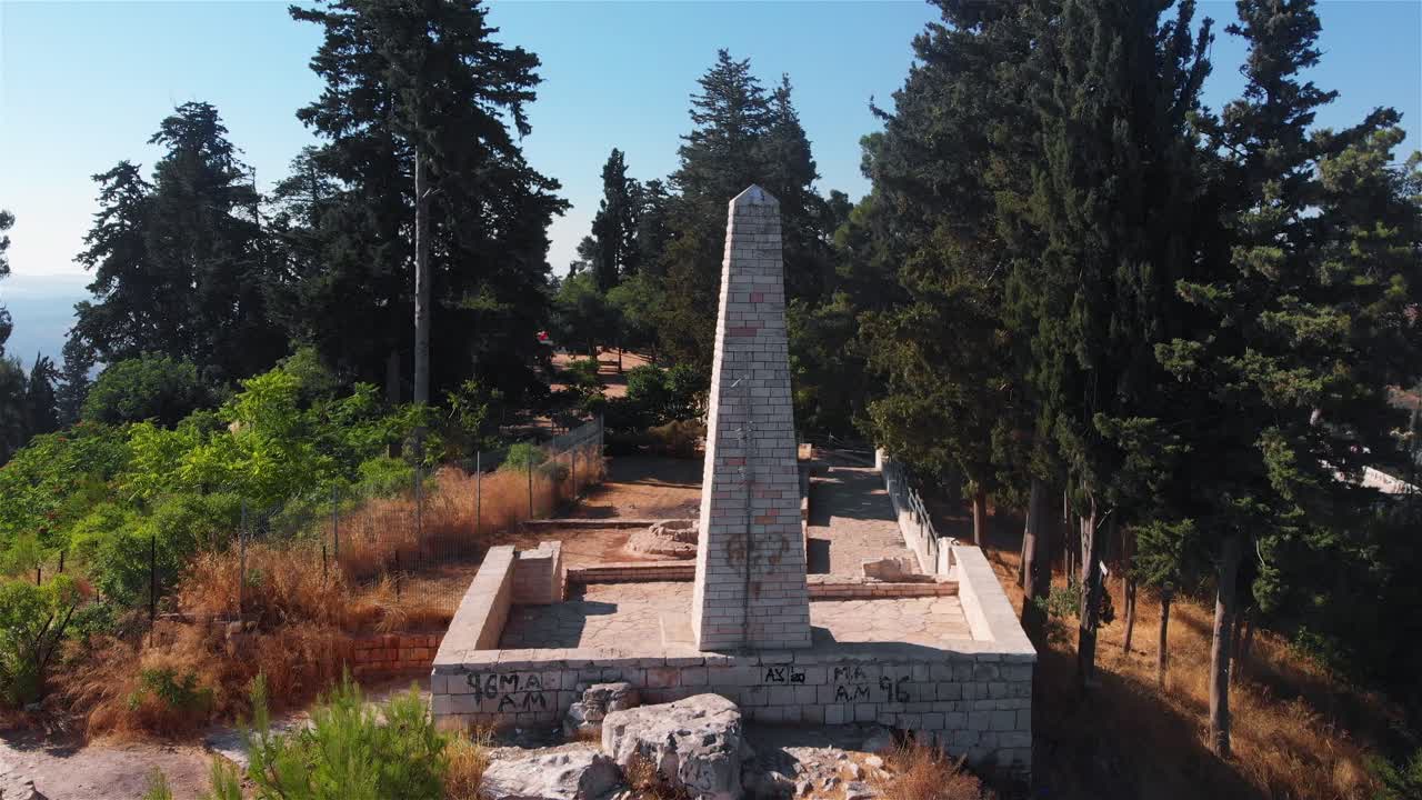 Aerial views of a stone monument and historical ruins in a forested park
