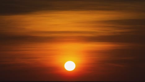 timelapse of a golden sunset overseas. round orange sundown into the water in the summer evening. landscape nature sunrise background. footage b roll of sun. yellow sunset sky. beautiful calm ocean.