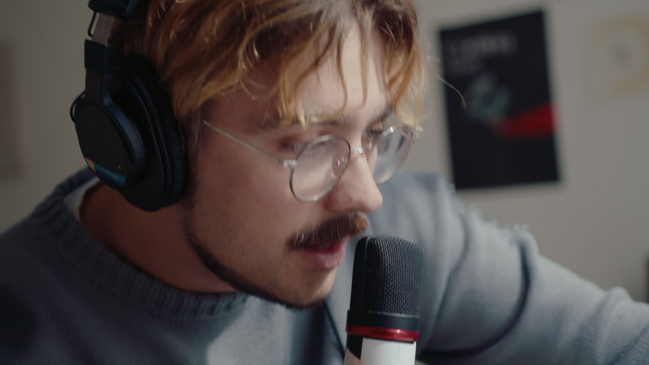 Musician in Headphones Recording a Song in Home Studio