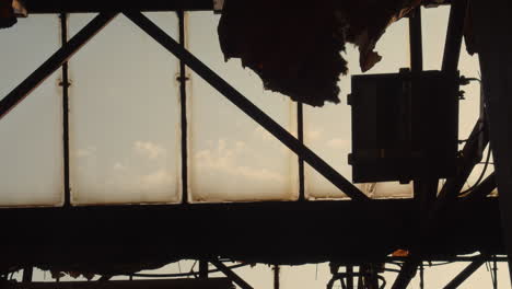 Silhouette-of-a-steel-beam-structure-supporting-the-glass-roof-of-an-old-industrial-building