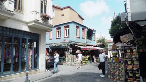 a vibrant street scene in istanbul, turkey, with people walking by shops and cafes.