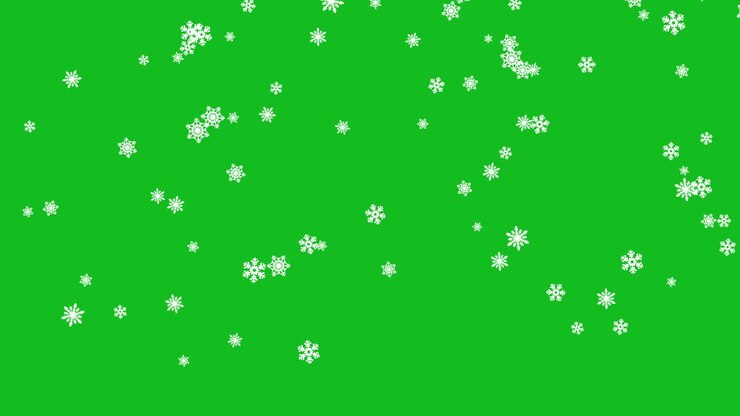 さまざまなサイズの小さな雪の結晶が緑色の画面の背景にゆっくりと落ちる