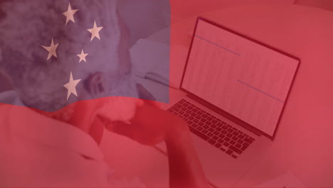 flag of china animation over person working on laptop with data