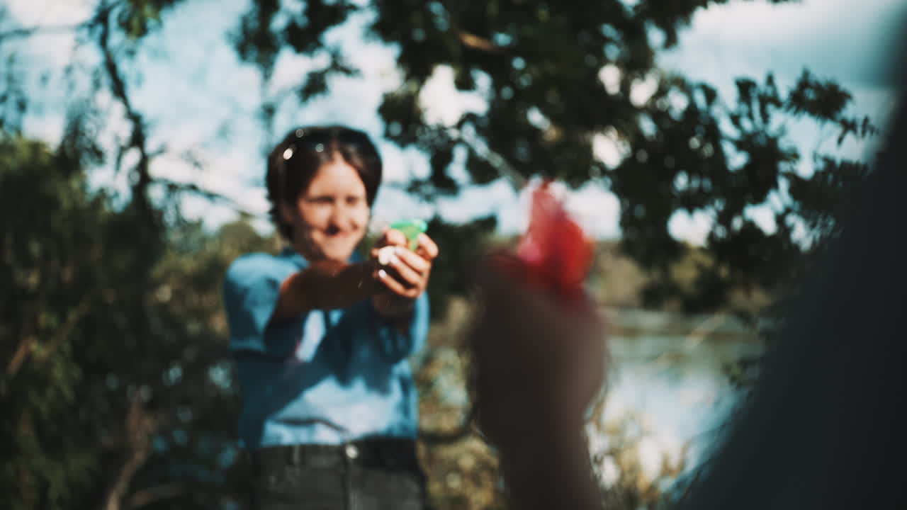 Blurred Water Gun Fight in the Park