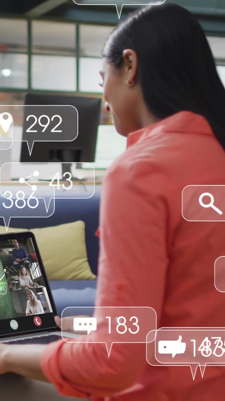 Vertical video: Woman placing laptop and typing, social metrics rising around laptop for marketing