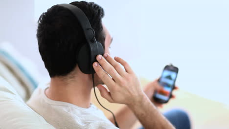 cheerful man listening to music with his phone