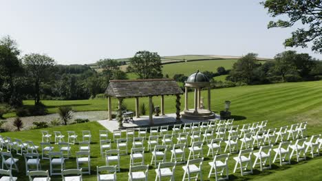 Empty-Rows-Of-White-Folding-Chairs-With-Dome