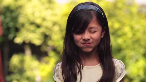 eight year old latin girl funny face and smile on blurry background