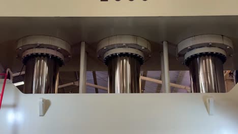 massive pistons of industrial hydraulic machine, close up view