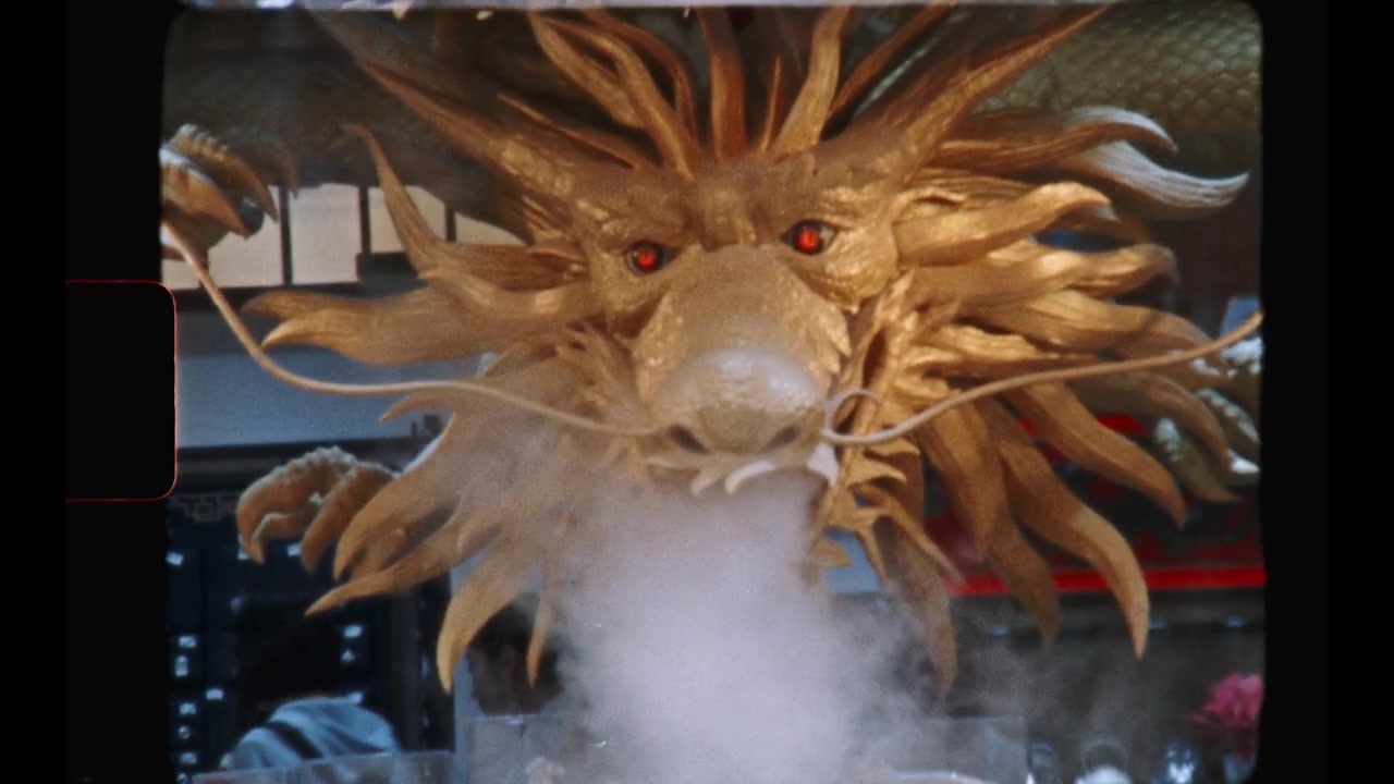 Golden Chinese Dragon Statue Exhaling Smoke in Front of Shop
